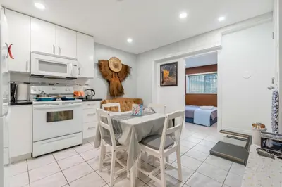 a kitchen and dining room with a table and chairs at Spacious 3BR with Full Kitchen a n dFast Wi-Fi in Vancouver
