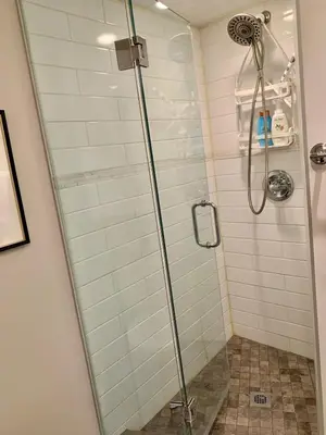a shower with a glass door in a bathroom at Cozy Boho Studio Suite in Calgary