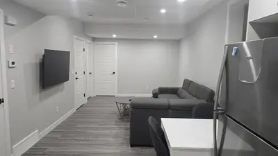 a living room with a couch and a tv at Royaldee Cozy Home in Calgary
