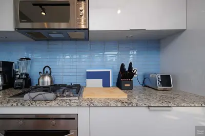 a kitchen with a counter top with a stove top oven at Spacious 2BD in Vancouver Patio with Ocean View in Vancouver