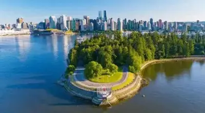 an island in the water with a city in the background at Spacious 2BD in Vancouver Patio with Ocean View in Vancouver