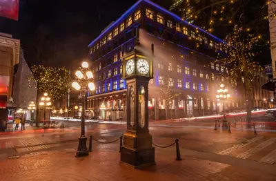 a clock tower on a city street at night at Spacious 2BD in Vancouver Patio with Ocean View in Vancouver