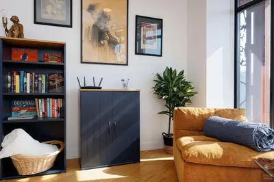 a living room with a chair and a book shelf at Spacious 2BD in Vancouver Patio with Ocean View in Vancouver