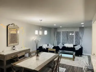 a living room with a table and a couch at Private Rooms in a Wonderful House in Hay River