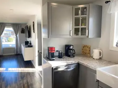 a kitchen with white cabinets and a counter top at Private Rooms in a Wonderful House in Hay River