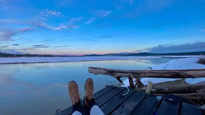a pair of skis sitting on top of a boat on the water at Suite on the Bay in Marsh Lake