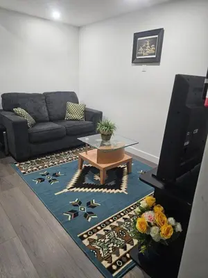 a living room with a couch and a coffee table at Affordable Comfort in Creekstone SW in Calgary