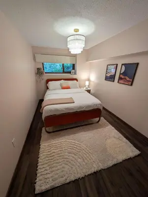 a bedroom with a large bed and a rug at Newly Renovated Shuswap Lake Cabin Multi-Family Retreat Sleeps 12 in Blind Bay