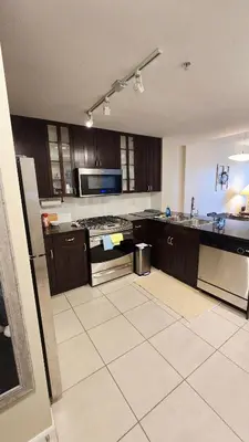 an empty kitchen with a stove and a refrigerator at Bright 2BR Close to Seabus, and Lower Lonsdale in North Vancouver