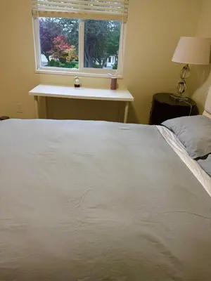 a white bed in a bedroom with a window at Maple & Moon in Richmond