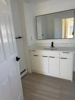 a bathroom with a white sink and a mirror at Maple & Moon in Richmond