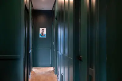 a hallway with green walls and a wooden bench at Revelstoke Mountain Penthouse in Revelstoke