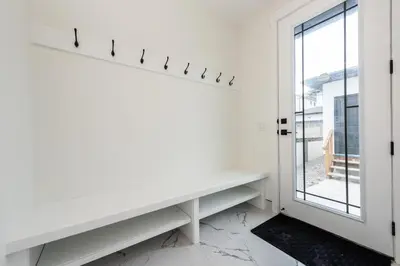 a white room with a window and a white table at Luxury Home Near DT, New Build, High-End Features in Calgary