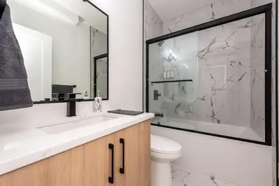 a bathroom with a sink and a toilet at Newly built 2 bedroom suite with kitchen & laundry in Calgary