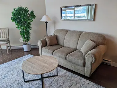 a living room with a couch and a table at Copper Sky Paradise in West Kelowna
