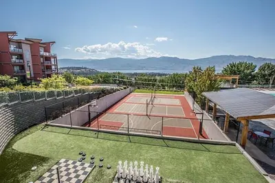 an outdoor tennis court with a tennis court at Copper Sky Paradise in West Kelowna