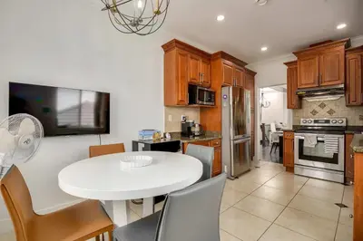 a kitchen with a white table and chairs in a room at Spacious Family Home in Vancouver in Vancouver