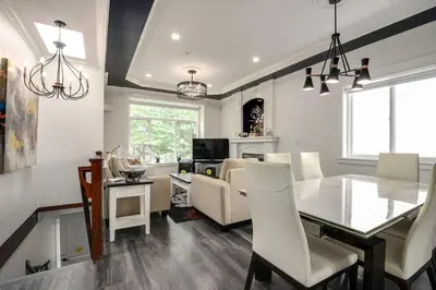 a dining room and living room with a table and chairs at Spacious Family Home in Vancouver in Vancouver