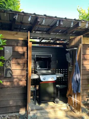 a outdoor kitchen with a stove and a oven at Studio Cedar Guest Cottage in Duncan
