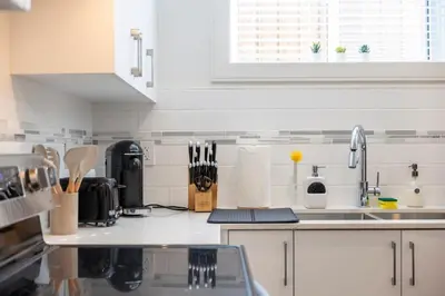 a kitchen with a sink and a counter top at Relaxing 2BR Stay - Kitchen & Central Convenience in Vancouver