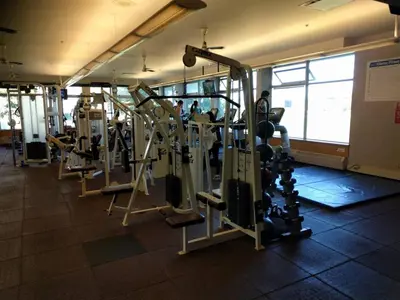 a gym with rows of tread machines in a room at Relaxing 2BR Stay - Kitchen & Central Convenience in Vancouver
