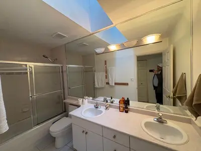 a person taking a picture of a bathroom at Vancouver Home - Downtown 15 Min, Transit Access - Free Parking & Wi-Fi in Vancouver