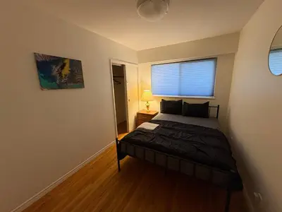 a bedroom with a bed and a window in a room at Vancouver Home - Downtown 15 Min, Transit Access - Free Parking & Wi-Fi in Vancouver