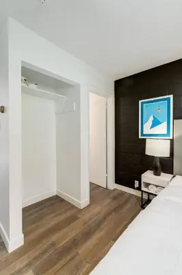 a bedroom with two beds and a black wall at Gateway Suites Rocky Mountains stay near Banff in Canmore