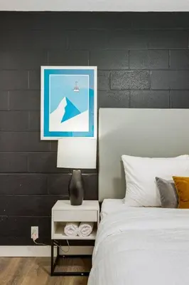 a bedroom with a bed and a picture on the wall at Gateway Suites Rocky Mountains stay near Banff in Canmore