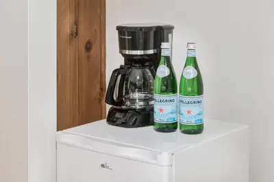 two bottles of wine sitting on top of a refrigerator at Gateway Suites Perfect rest on your way to Banff in Canmore