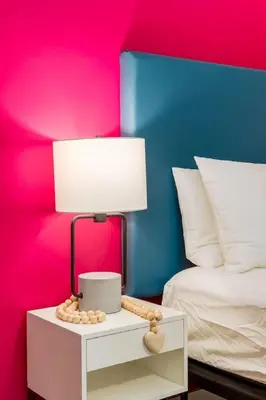 a lamp on a night stand next to a bed at Gateway Suites Perfect rest on your way to Banff in Canmore