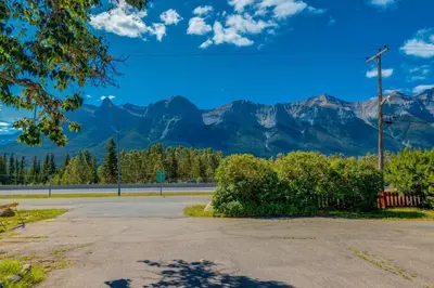 an empty parking lot with mountains in the background at Gateway Suites Charming Stay perfect for 4 Guests in Canmore