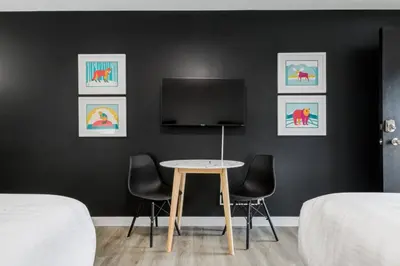 a room with a table and two chairs and a tv at Gateway Suites Charming Stay perfect for 4 Guests in Canmore