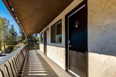 a porch of a house with a black door at Gateway Suites near Banff in Canmore