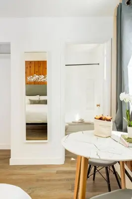 a white room with a table and a mirror at Gateway Suites near Banff in Canmore