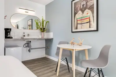 a room with a table and a mirror at Gateway Suites Perfect Escape to explore Banff in Canmore