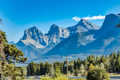 a mountain range with a cross in the foreground at Gateway Suites Cozy stay to explore Banff and Canmore in Canmore