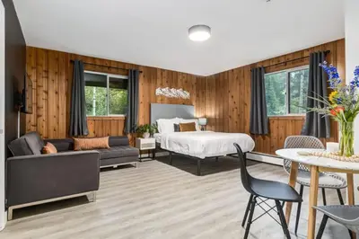 a bedroom with a bed and a living room at Gateway Suites Near Canmore and Banff in Canmore
