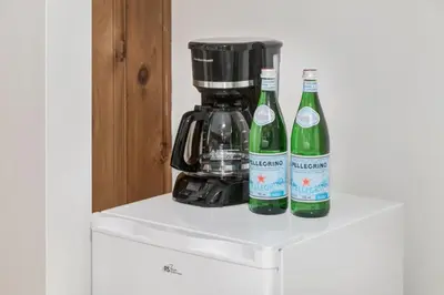 two bottles of wine sitting on top of a refrigerator at Gateway Suites Near Canmore and Banff in Canmore