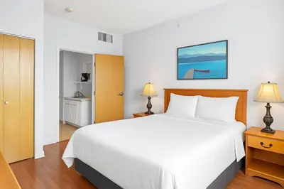 a bedroom with a large white bed and two lamps at Stylish 1BR Haven in CanmoreDT near Banff Sleeps 4 in Canmore