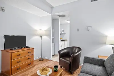 a living room with a couch and a chair at Stylish 1BR Haven in CanmoreDT near Banff Sleeps 4 in Canmore