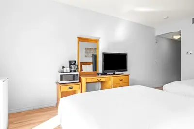 a bedroom with a bed and a flat screen tv at Mini Getaway with Mountain Views Near Banff in Canmore