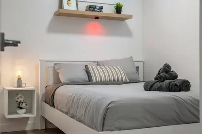 a bedroom with a bed with two stuffed animals on it at Modern 2BR Private Suite Near Calgary Airport in Calgary