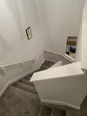 a room with a staircase with a white counter at Sunny's Homes in Edmonton
