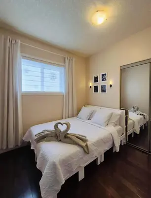 a bedroom with two beds with towels on them at Central 3 Bedroom Gem Near ICE District - Stadium and Malls in Edmonton