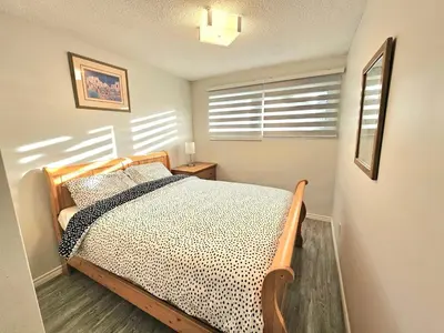 a bedroom with a bed and a window with blinds at Kirvia's retreat 