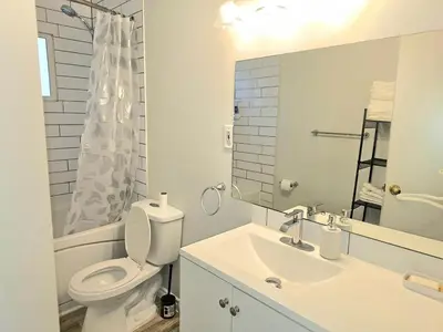 a white bathroom with a toilet and a sink at Kirvia's retreat 