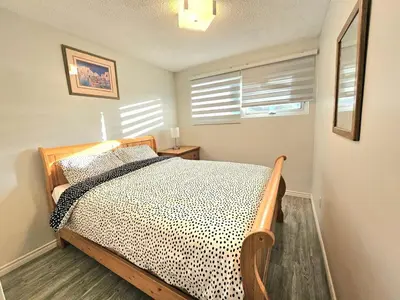 a bedroom with a bed and a window with blinds at Kirvia's retreat 