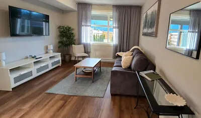 a living room with a couch and a tv at Lakeview Escape in Northshore Estates in Lake Cowichan