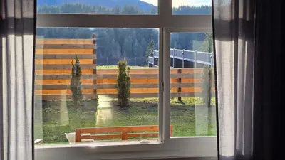 a window with a bench looking out at a fence at Lakeview Escape in Northshore Estates in Lake Cowichan